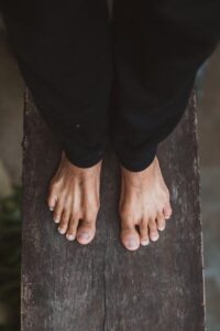 Modelo muestra pies sanos sobre una superficie de madera